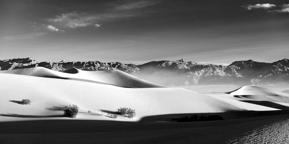A black and white image of sunrise at the sand dunes of Death Valley
