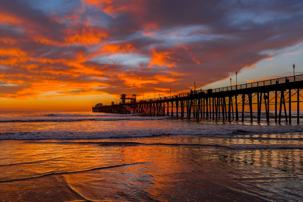 A brilliant winter sunset punctuates the sky over the Pier along the California Coast in Oceanside