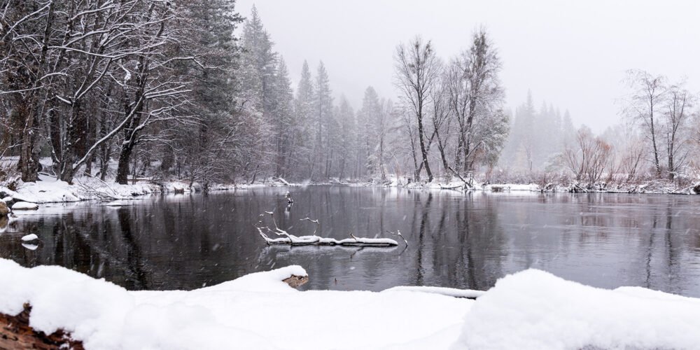A panorama of a winter storm bringing snow and ethereal silence to Yosemite Valley's Merced River revealing another side to the beauty of nature.