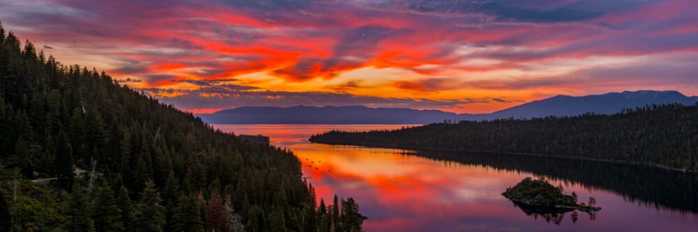 Lake Tahoe is beautiful, as in this picture showing sunrise reflecting in the lake and framed by mountains