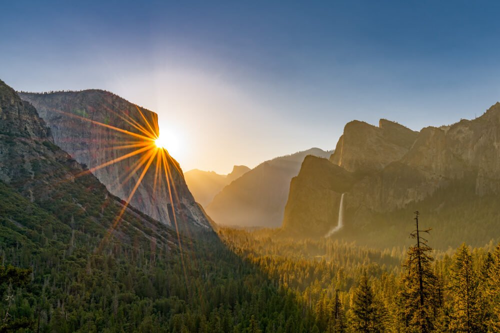 Dawn's first light highlights beautiful El Capitan, Bridalveil Fall and Half Dome in the forests, mountains, and waterfalls of Yosemite National Park