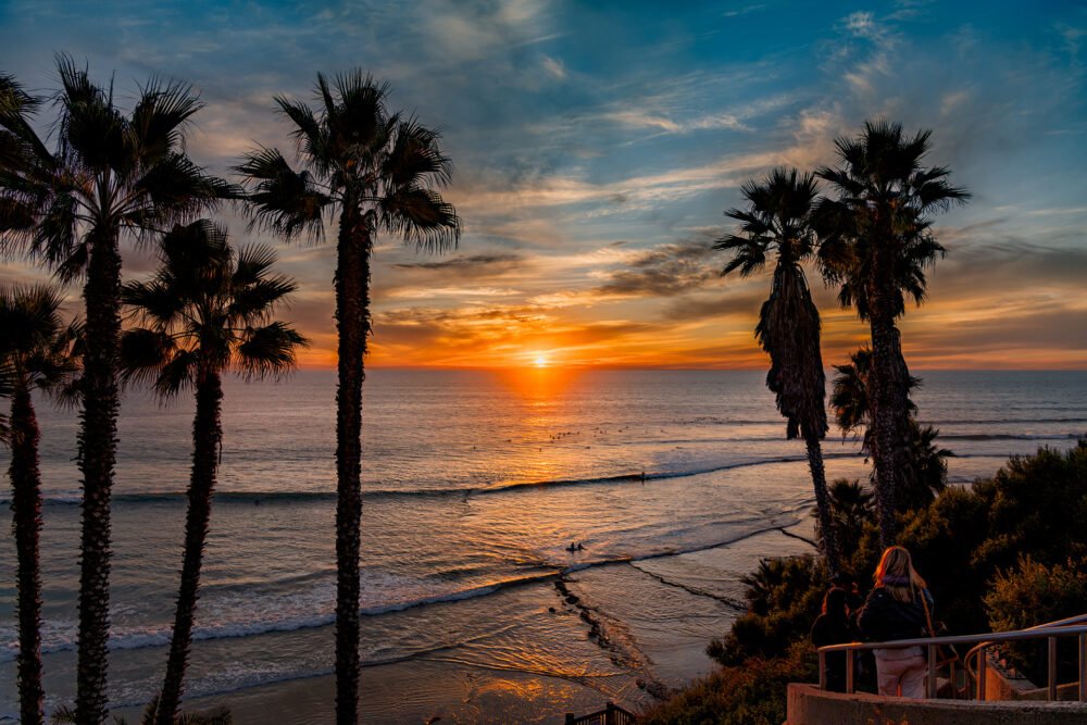 Surfing and watching the approaching sunset at Swami's Beach along the Pacific coast