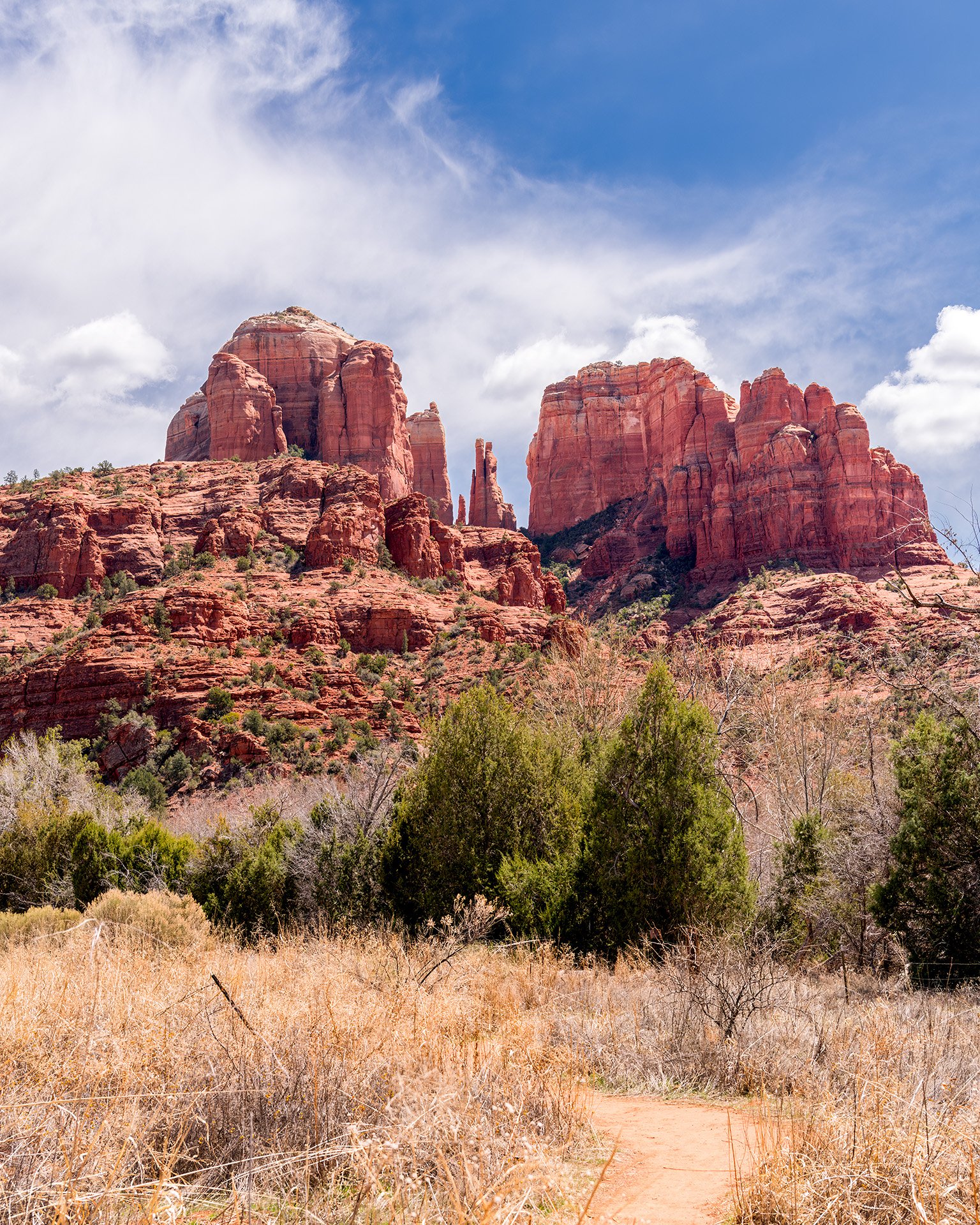 A trail near Oak Creek that leads to the Sedona Arizona sandstone butte and landmark Cathedral Rock, that stands in the background