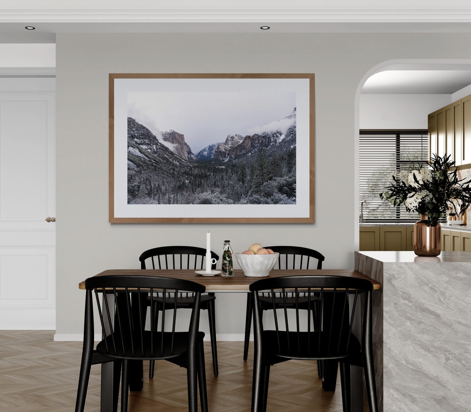 Clouds add drama to Yosemite Valley after a winter storm highlighting the beauty of nature in dramatic mountains, frozen waterfalls and forests dusted in snow. On display in dining area with a view to the kitchen.